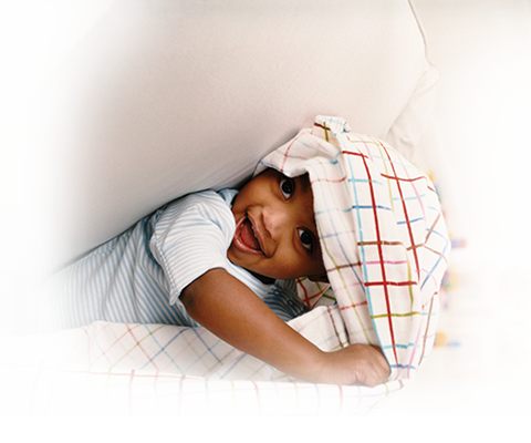 Child peeking out of blanket.