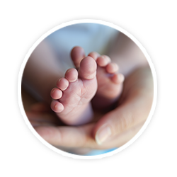 baby feet being held in hand