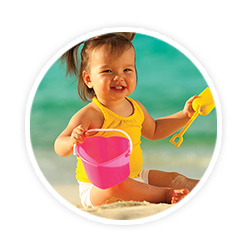 little girl playing with shovel and bucket at beach