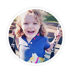 happy toddler girl on swing